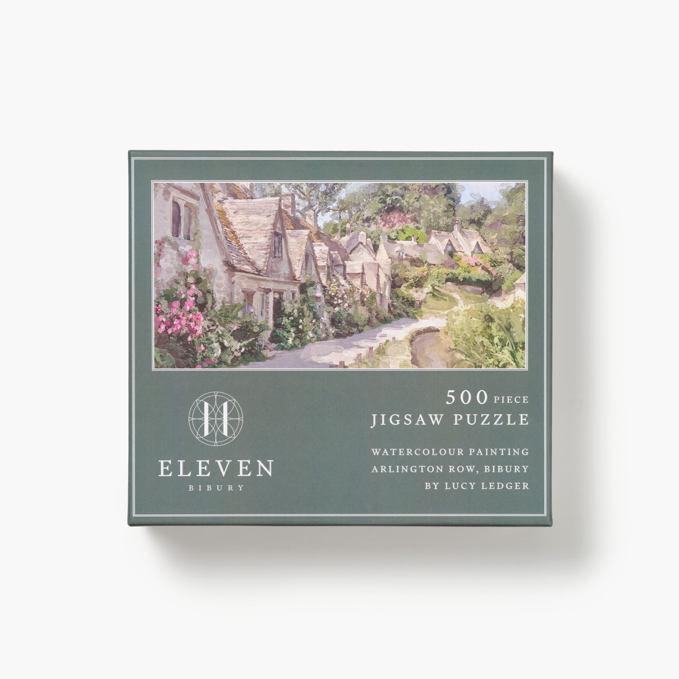 Jigsaw puzzle box with a scenic illustration of a village on a white background