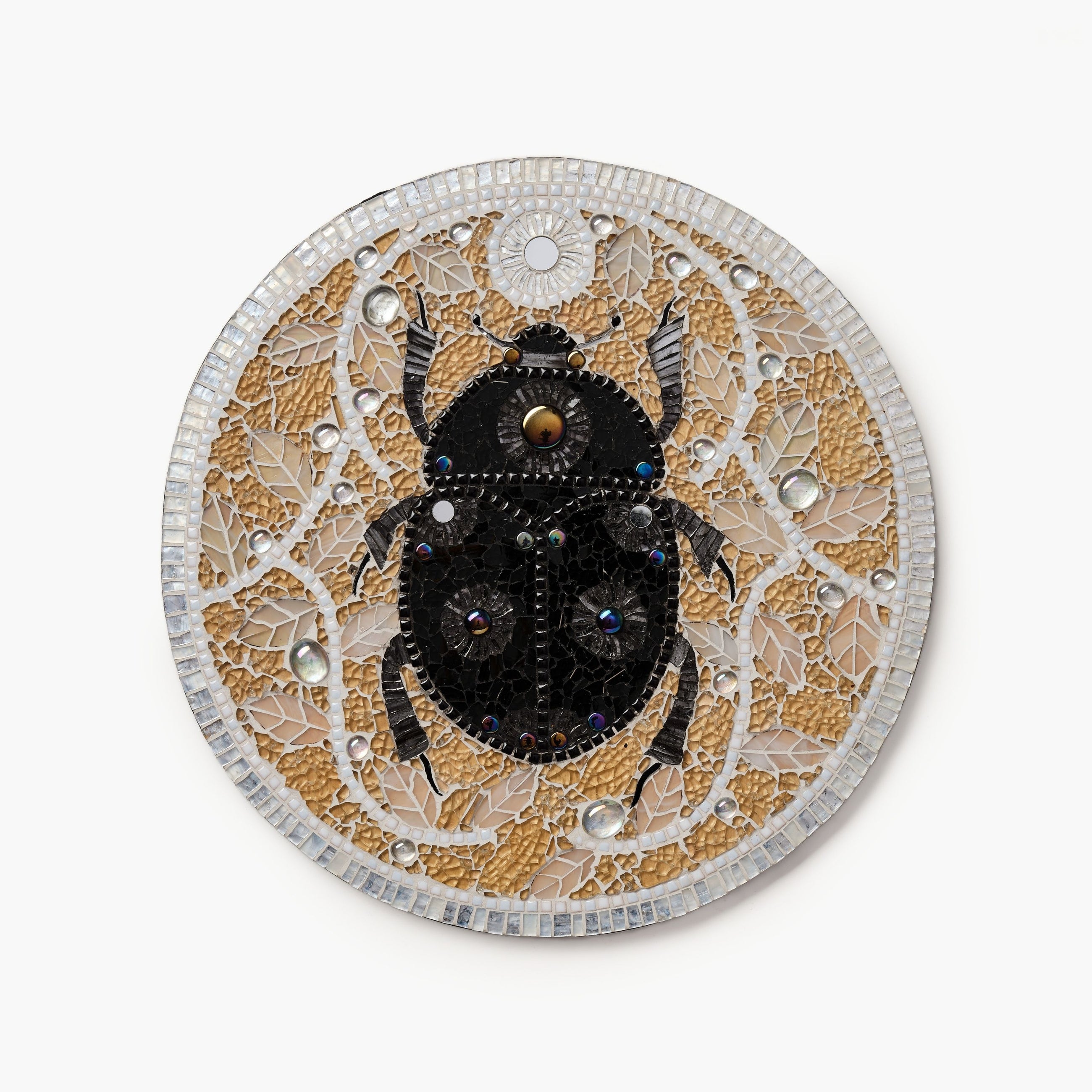 Decorative mosaic with a beetle design on a white background