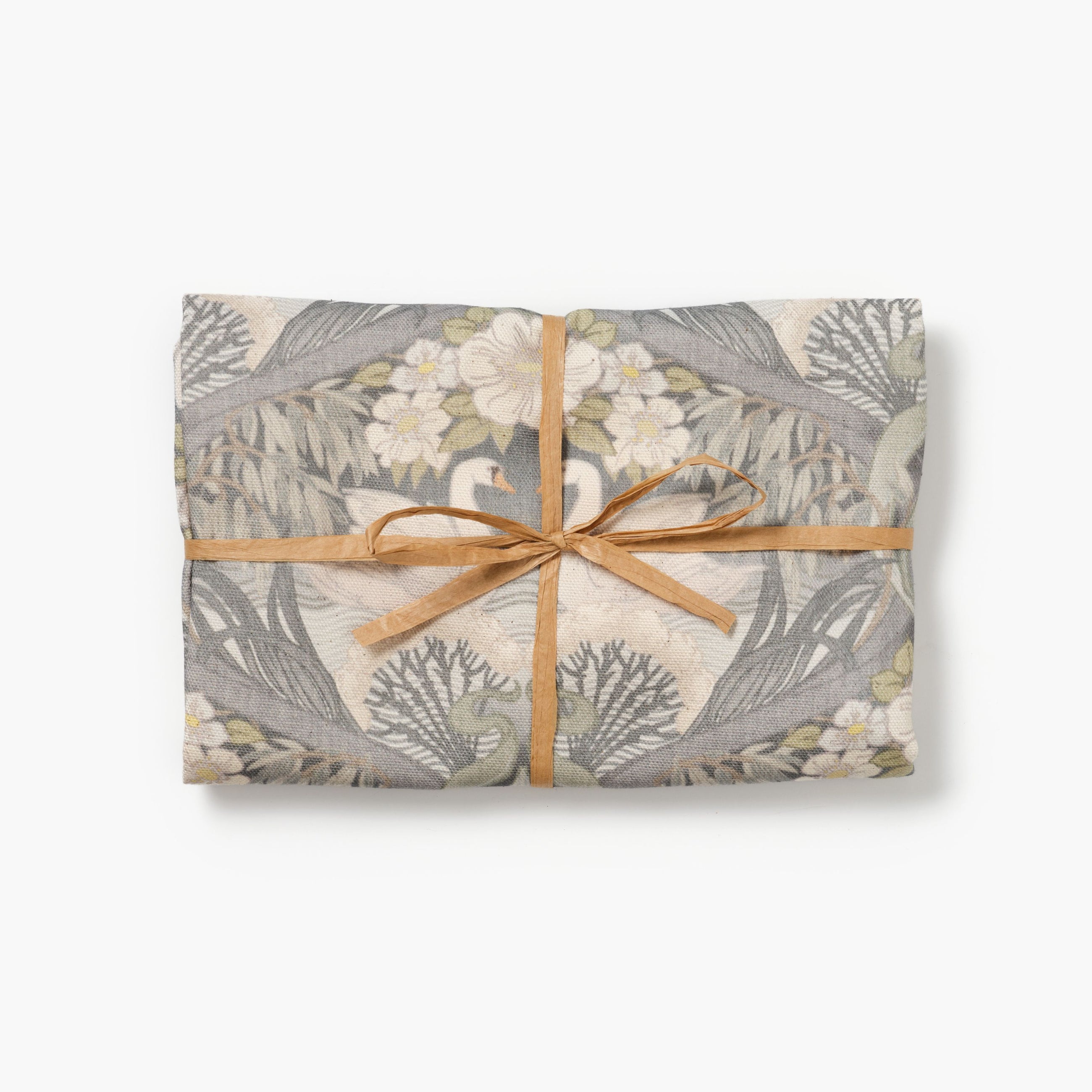 Bibury Swan folded tea towel tied with raffia on a white background