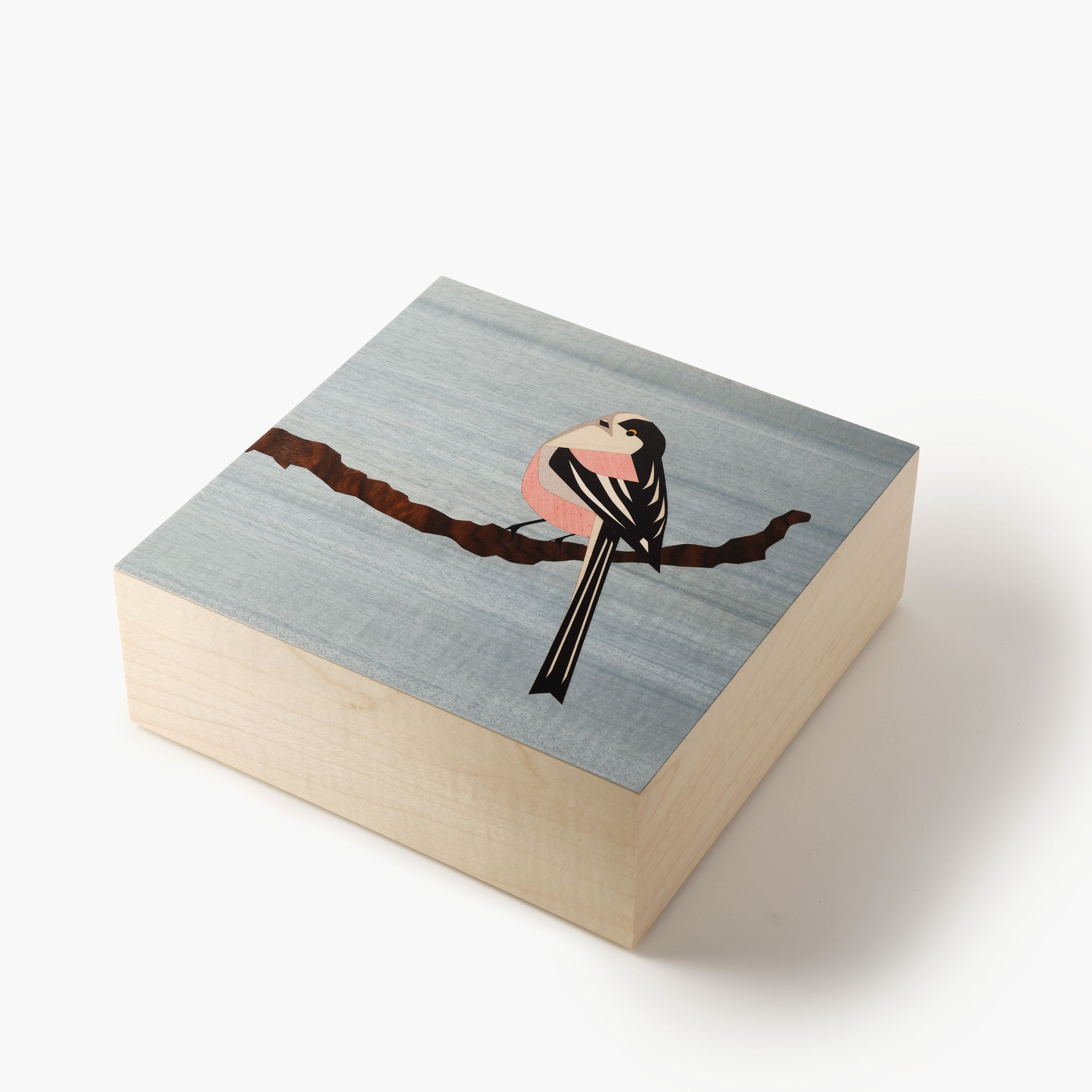 Wooden box with a bird illustration on a gray background