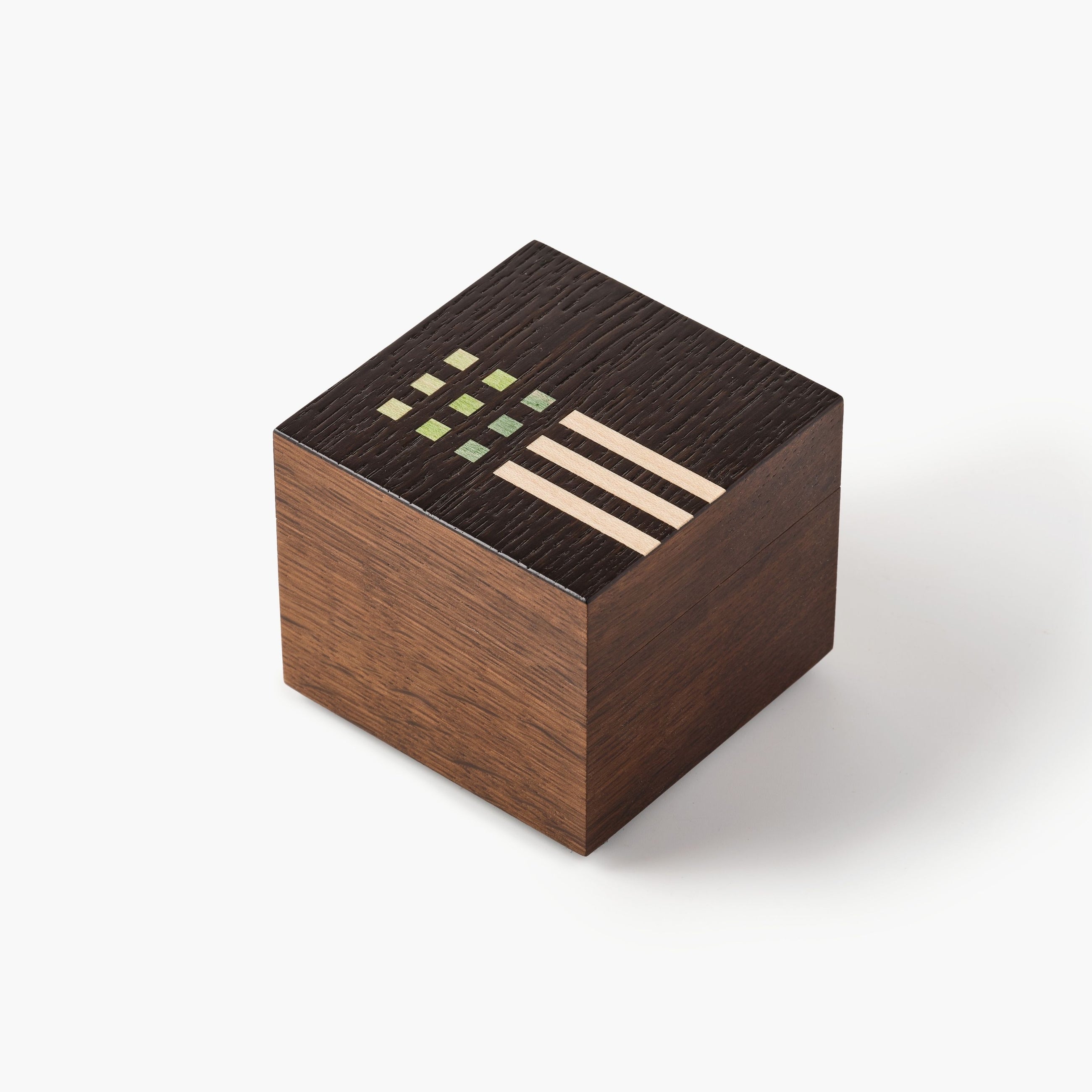 Wooden cube with geometric patterns on a white background