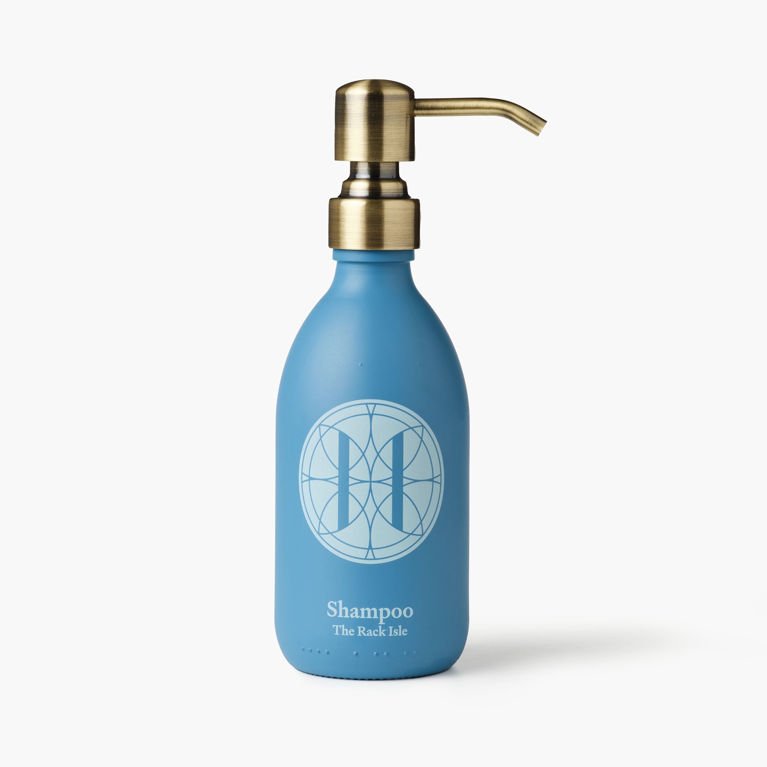 Eleven Bibury 'Rack Isle' blue shampoo bottle with gold pump on a white background