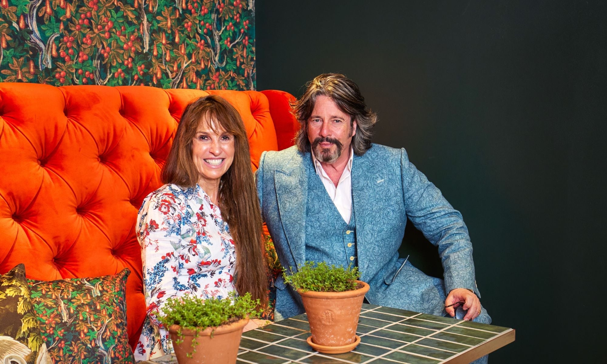 Photo of Laurence Llewelyn-Bowen and Lady Anne Evans on a sofa