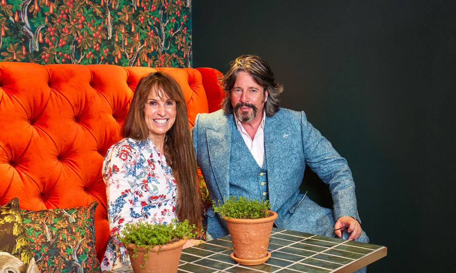 Photo of Laurence Llewelyn-Bowen and Lady Anne Evans on a sofa
