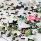 Close-up of puzzle pieces with various images on a white background