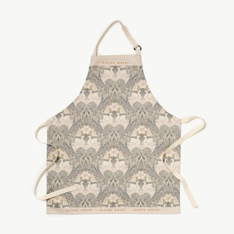 Bibury Swan patterned apron with Eleven Bibury logo on a white background