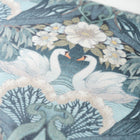 Close up of decorative Bibury Swan fabric with swans and floral patterns on a blue background