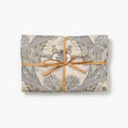 Bibury Swan folded tea towel tied with raffia on a white background