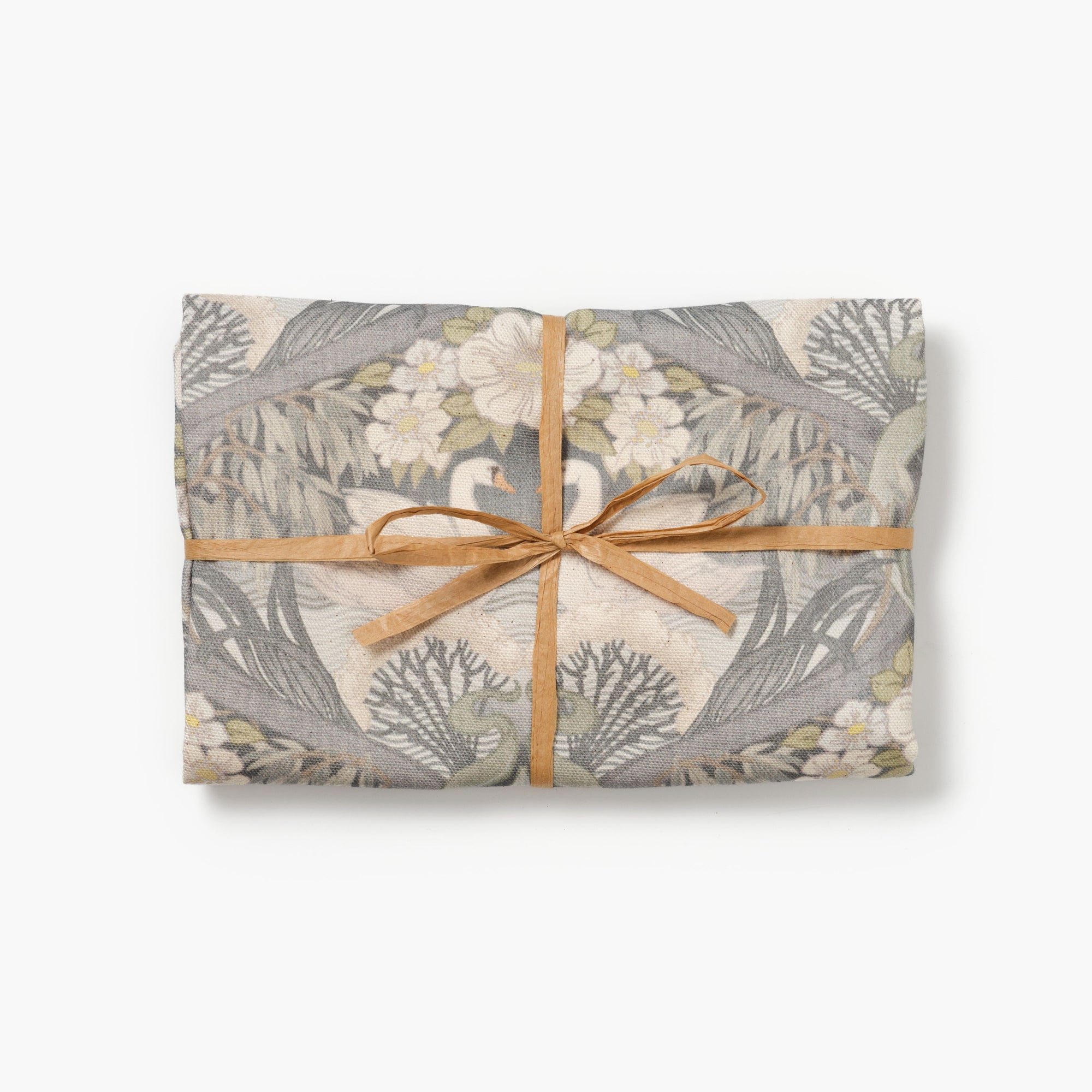 Bibury Swan folded tea towel tied with raffia on a white background