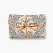 Bibury Swan folded tea towel tied with raffia on a white background