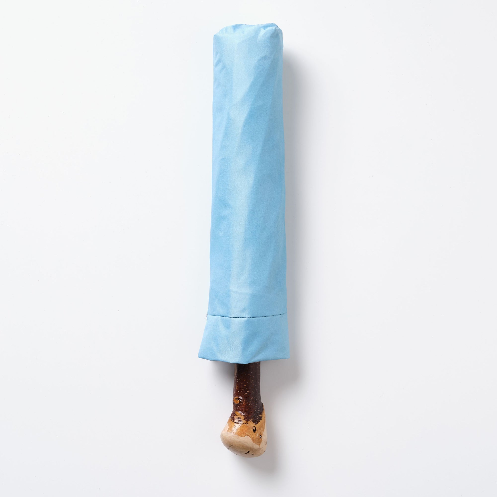 Blue umbrella with a wooden handle on a white background
