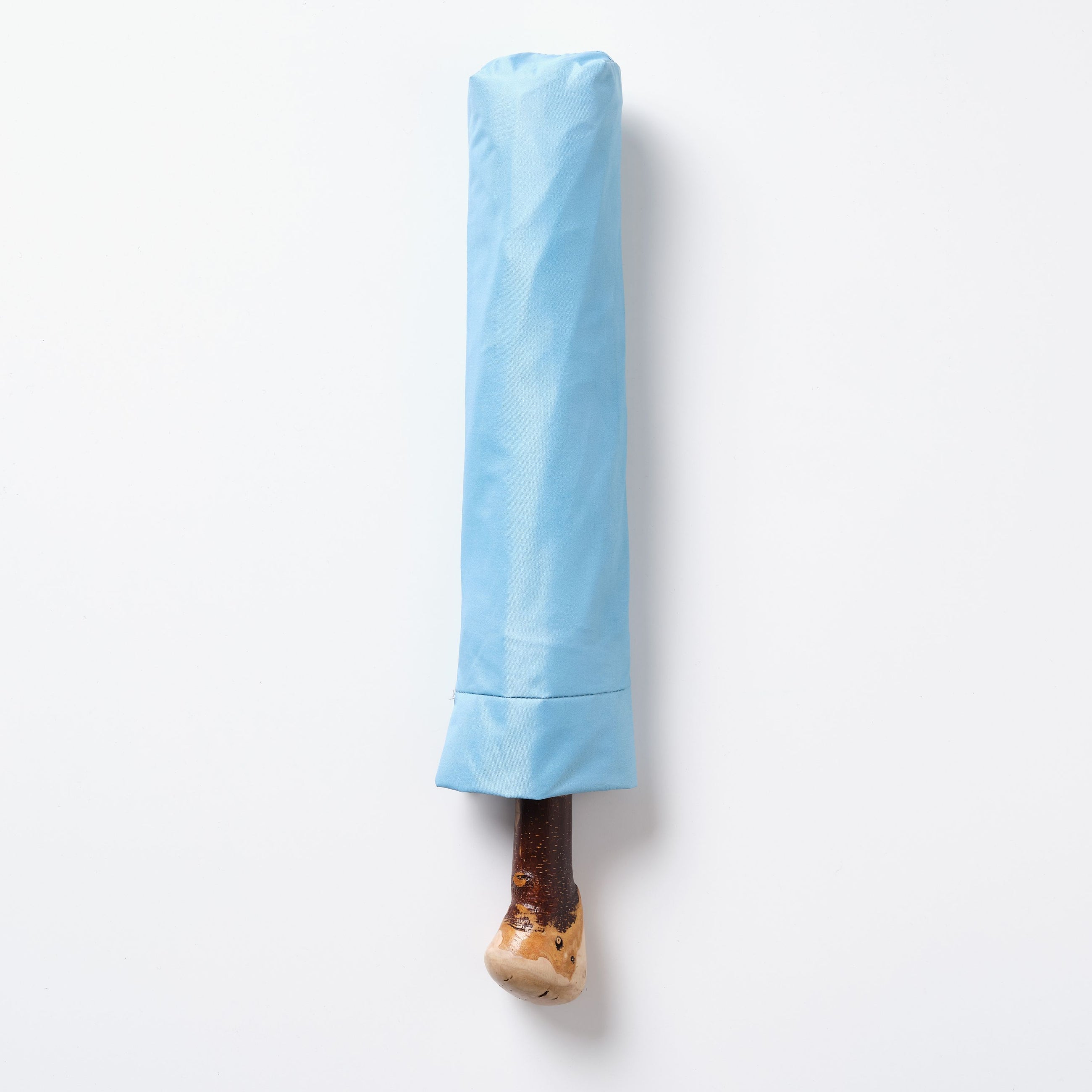 Blue umbrella with a wooden handle on a white background