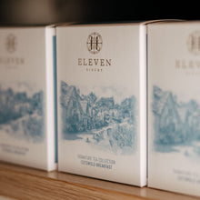 Three boxes of Eleven Bibury tea on a wooden surface