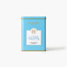 Blue decaf coffee tin with 'Eleven Bibury' branding on a white background