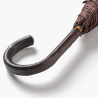 Close up of chestnut crook handle on umbrella