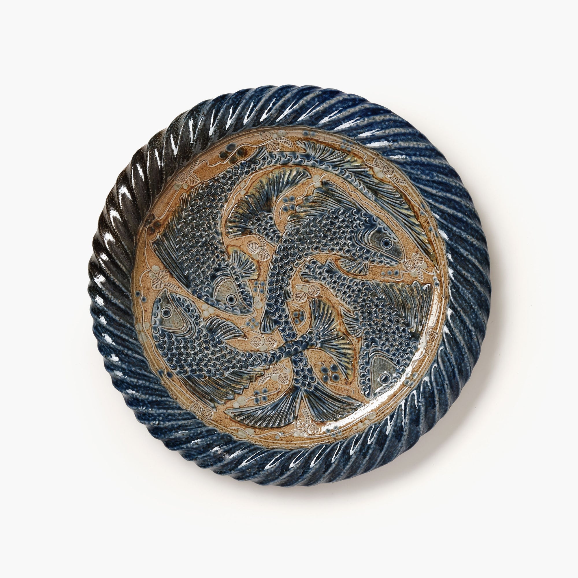 Decorative plate with fish design on a white background