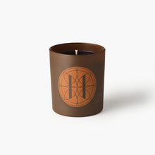 Eleven Bibury 'Gabriel's Muse' Brown candle with a circular design on a white background