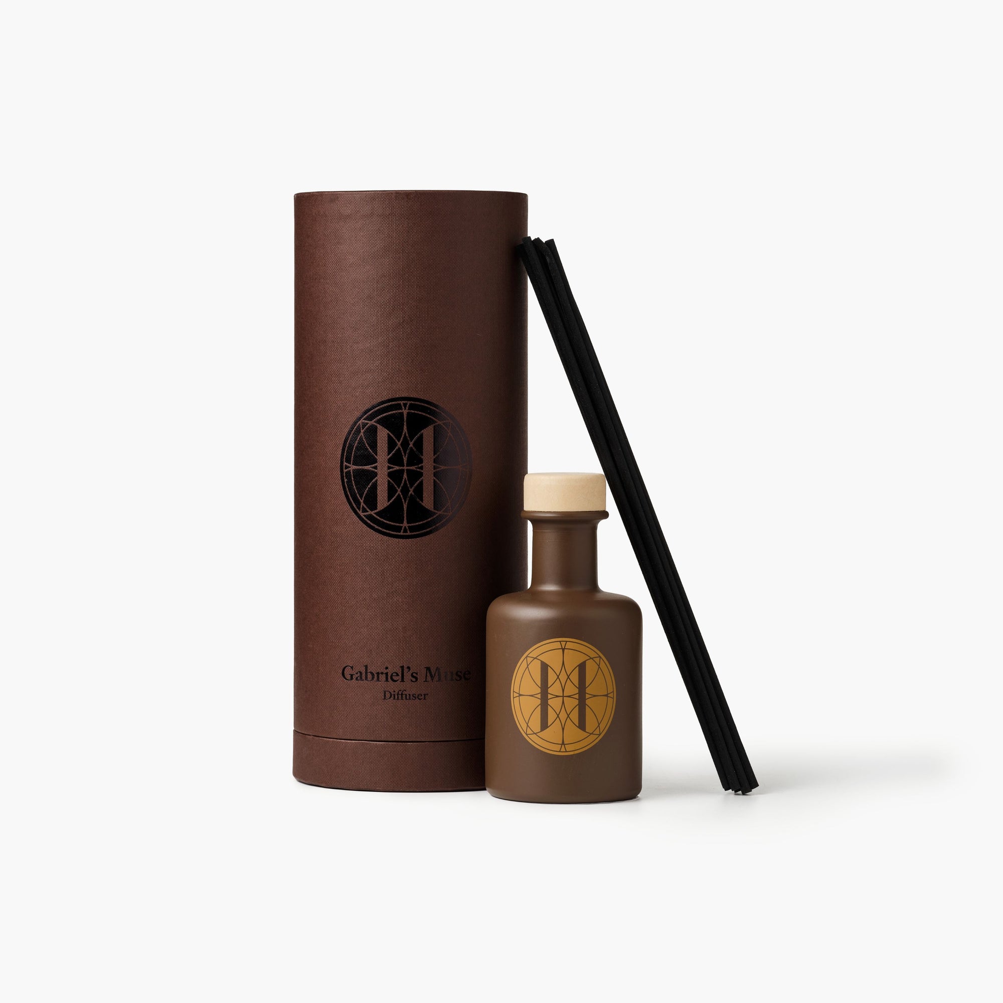 Eleven Bibury 'Gabriel's Muse' diffuser with brown cylindrical container and bottle with logo on a white background
