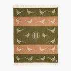 Woven throw with pheasant pattern on a white background