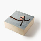 Wooden box with a bird illustration on a gray background