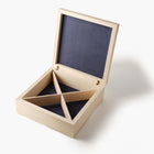 Wooden jewelry box with a dark interior on a white background
