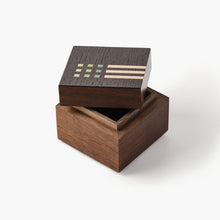 Wooden box with geometric patterns on a white background
