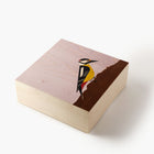 Wooden block with a bird illustration on a white background