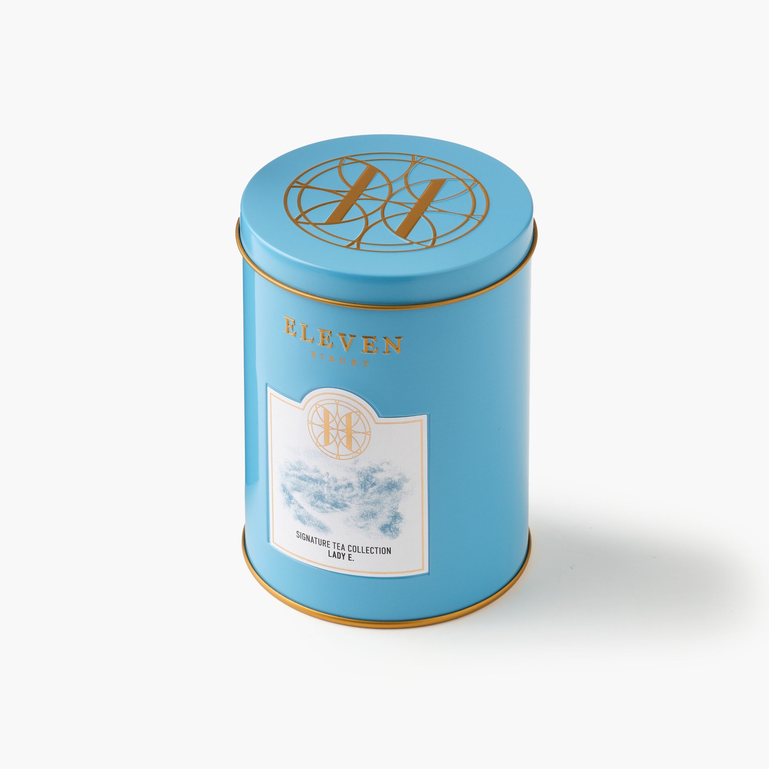 Blue Lady E tea canister with 'Eleven Bibury' branding and gold accents on a white background