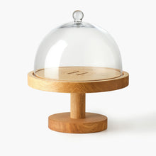 Large round wooden stand engraved with Eleven Bibury logo with a glass dome on a white background