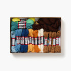 Box of colorful yarn and embroidery threads on a white background