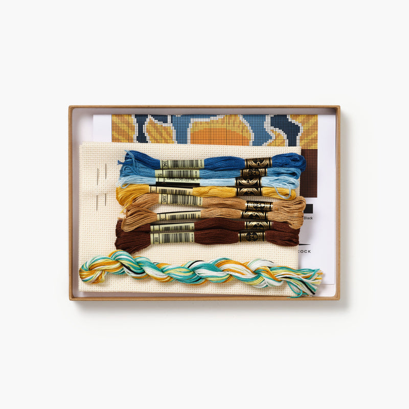 Set of embroidery threads in a decorative wooden box with a white background