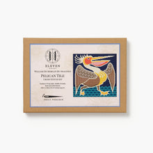 Cross stitch kit packaging with pelican design on a white background