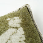 Close-up of a green and white pheasant cushion corner on a light background