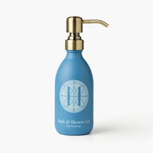 Eleven Bibury 'Rack Isle' blue bottle of bath and shower gel with a gold pump on a white background
