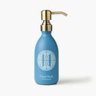 Eleven Bibury 'Rack Isle' blue hand wash bottle with gold pump on a white background