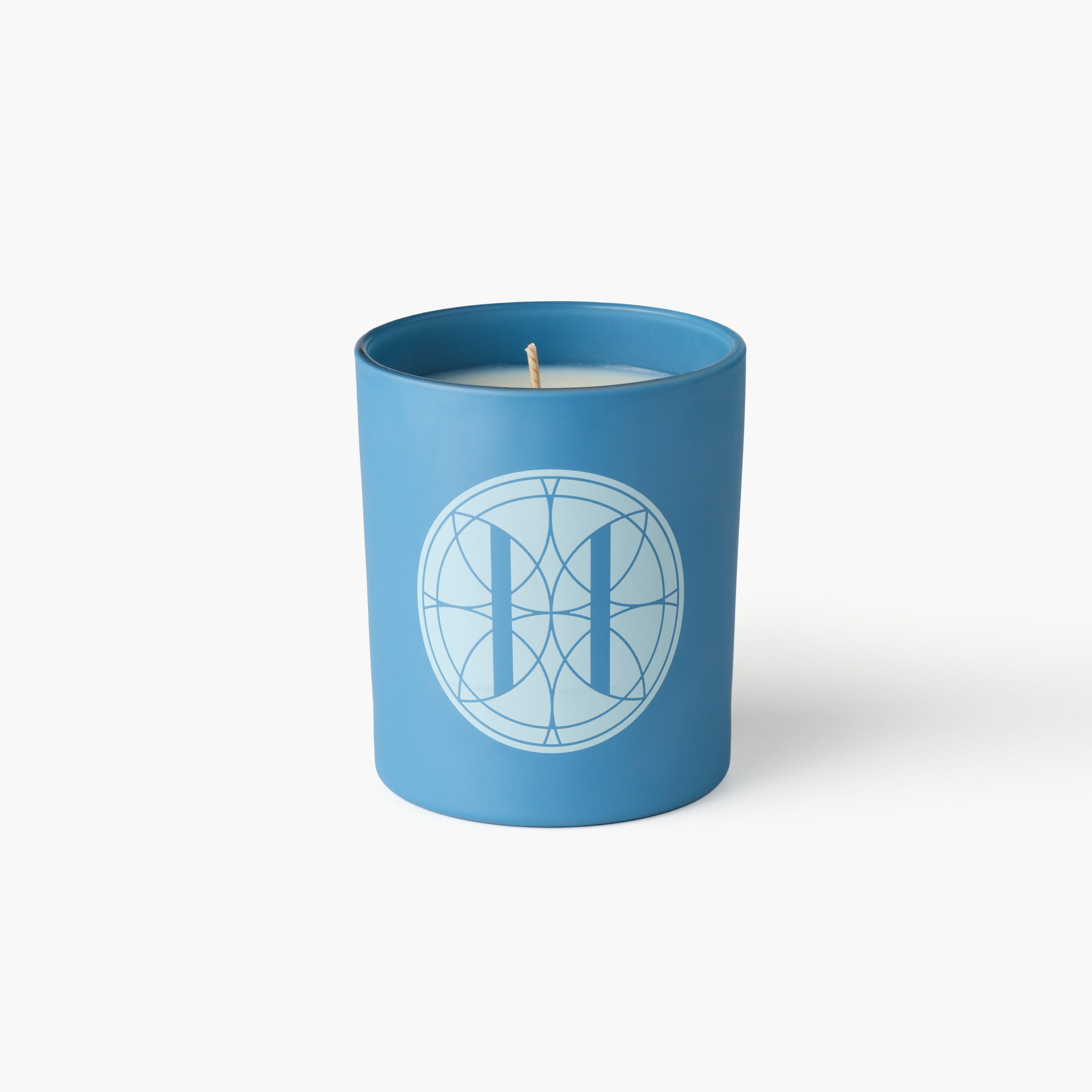 Eleven Bibury 'Rack Isle' Blue candle with a geometric design on a white background