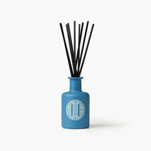 Eleven Bibury 'Rack Isle' blue diffuser bottle with black sticks on a white background