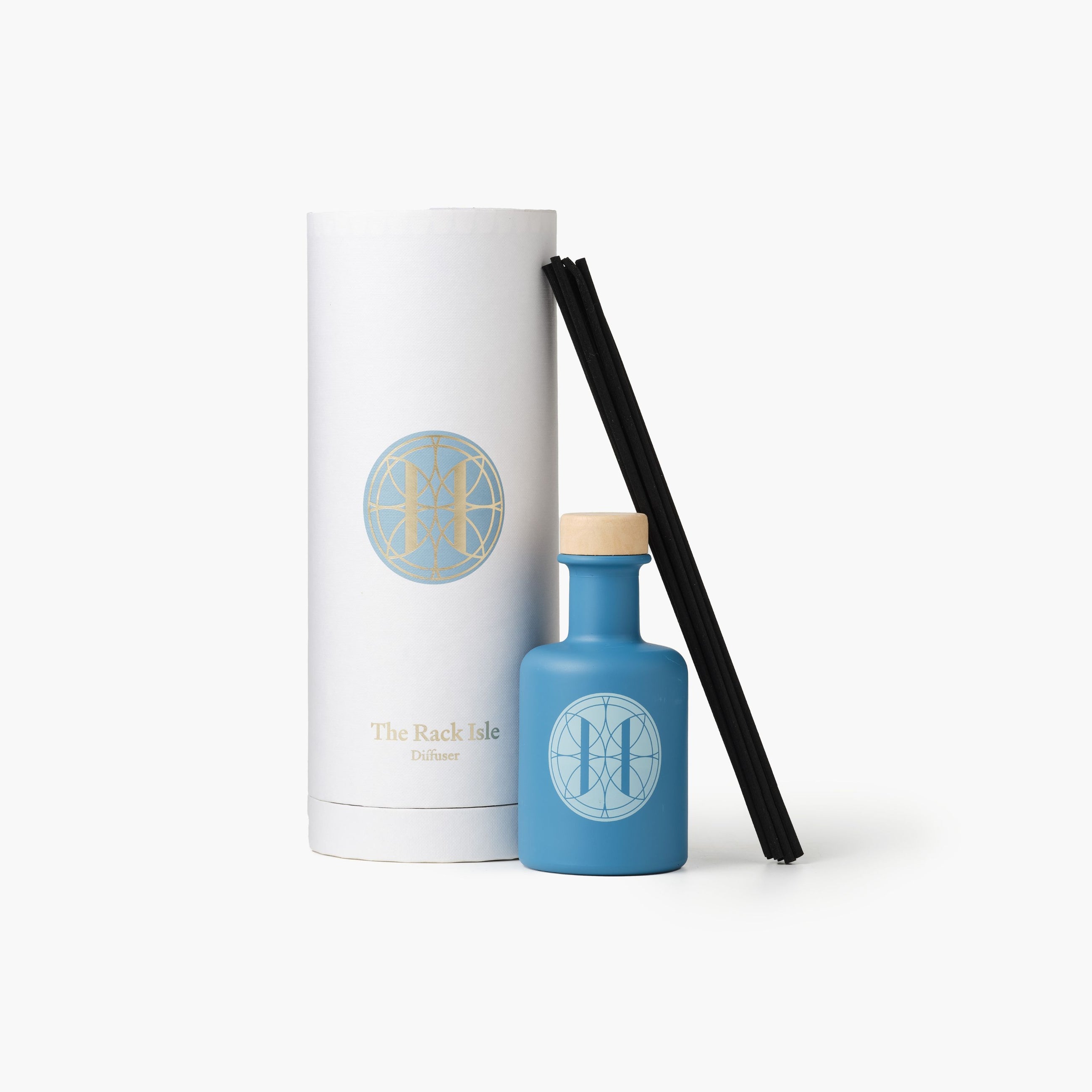Eleven Bibury 'Rack Isle' blue diffuser bottle with white cap and cylindrical white container with logo on a white background