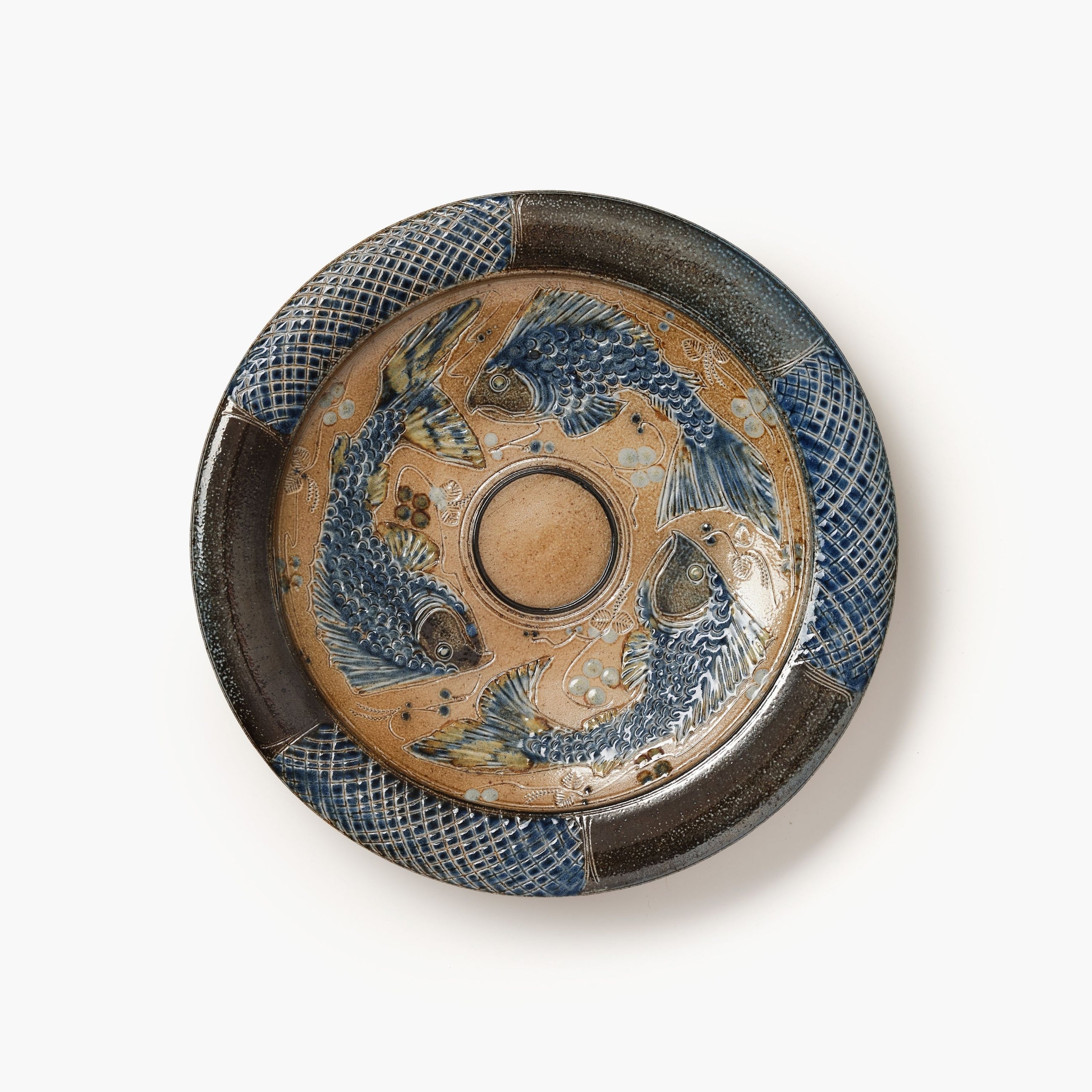 Decorative ceramic plate with fish design on a white background