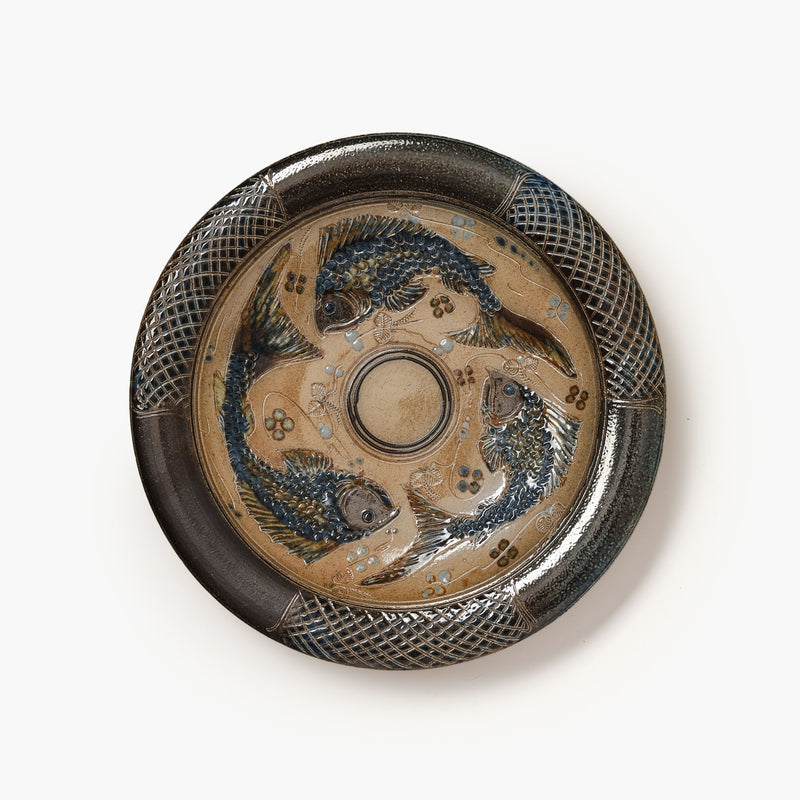 Decorative ceramic plate with dragon design on a white background