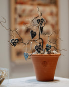 Small terracotta pot with hanging ceramic hearts