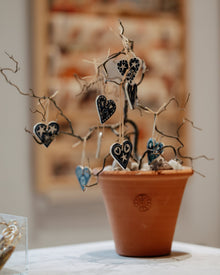 Small terracotta pot with hanging ceramic hearts