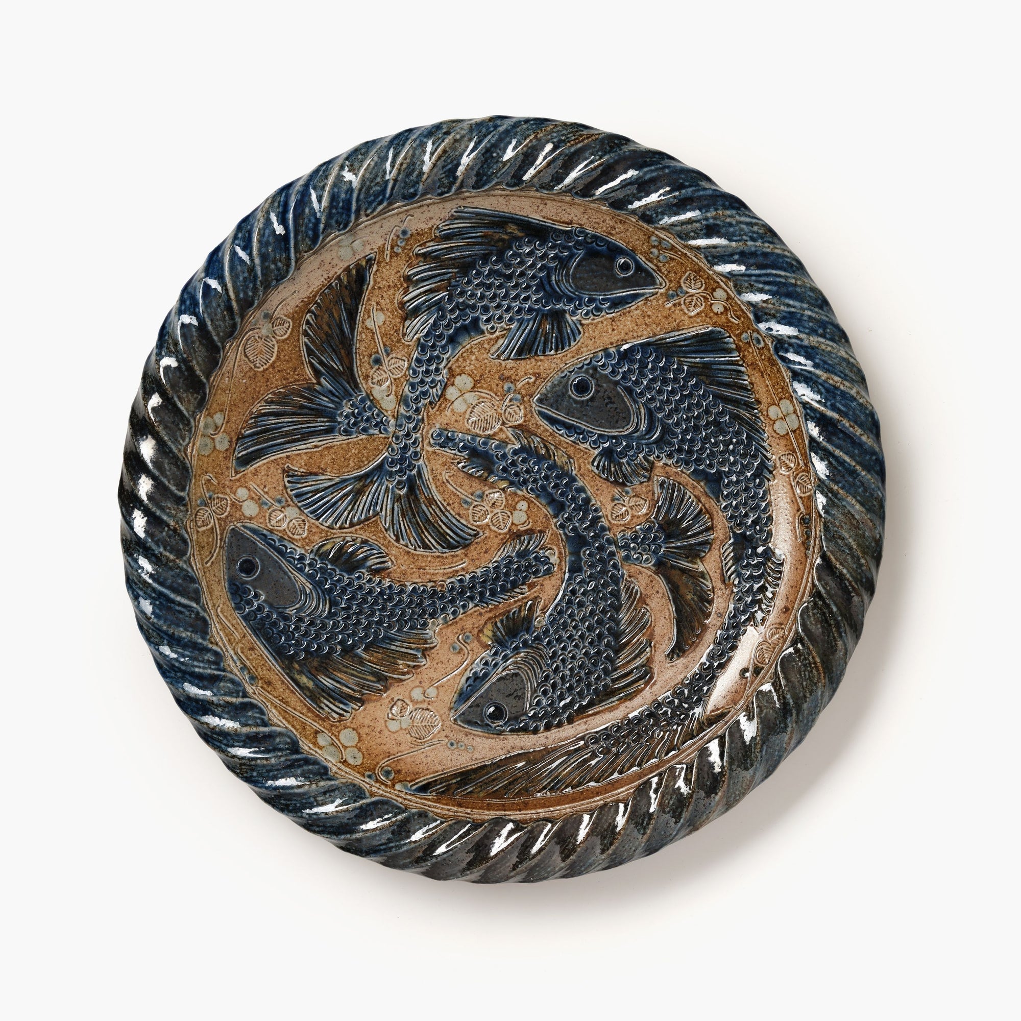 Decorative plate with fish design on a white background