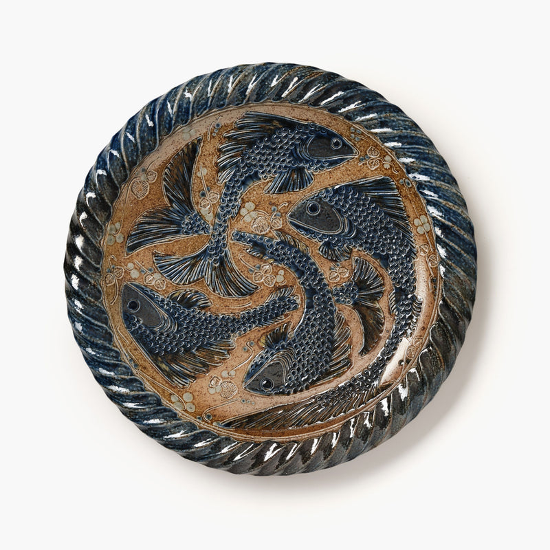 Decorative plate with fish design on a white background