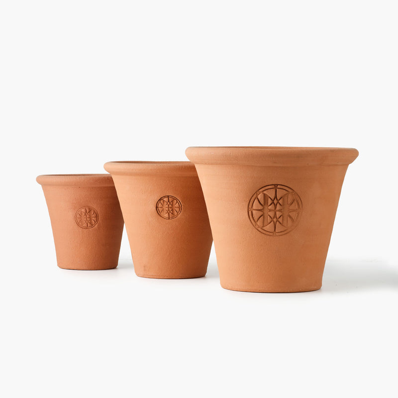 Three terracotta pots with a Eleven Bibury logo on a white background