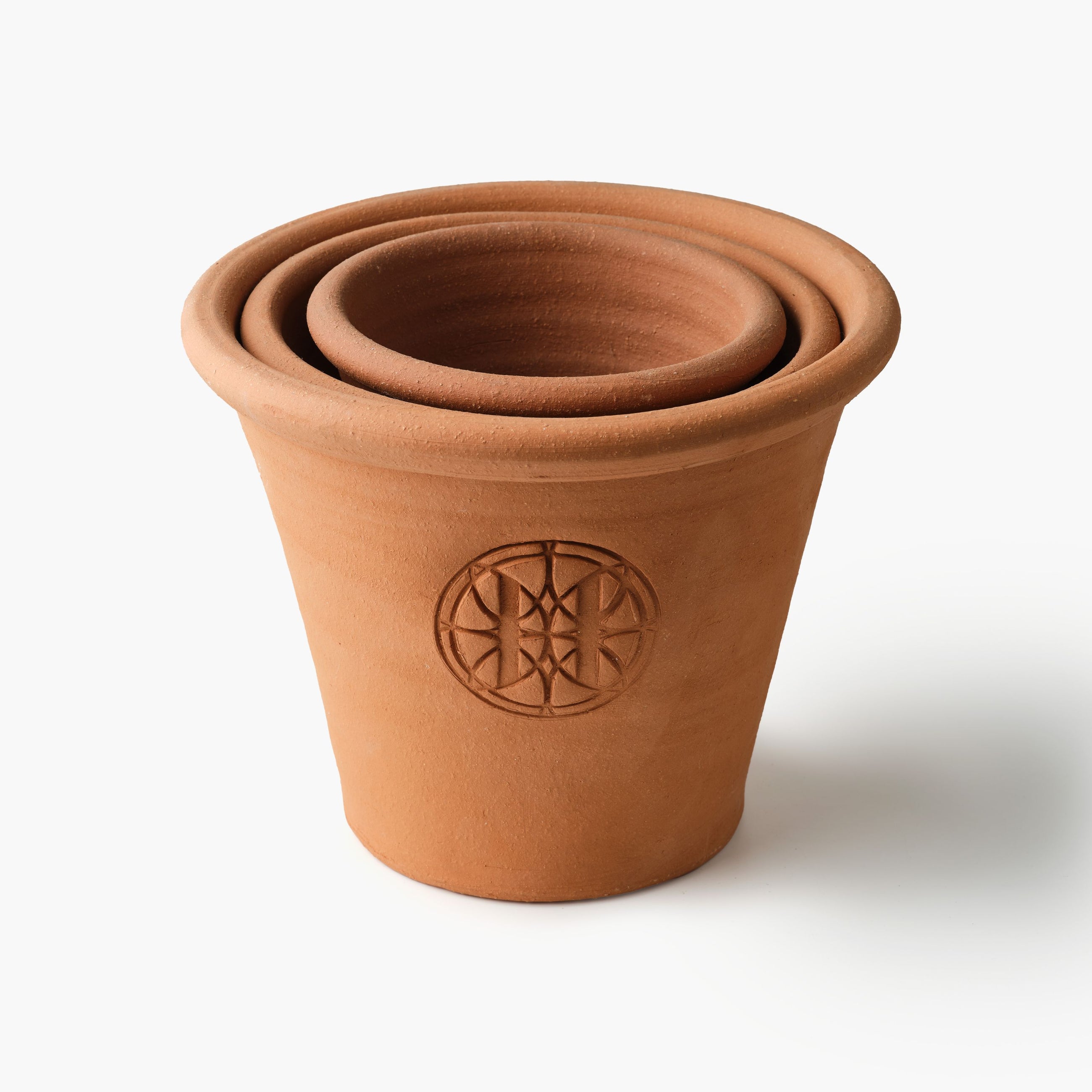 Stack of terracotta pots with Eleven Bibury logo on a white background
