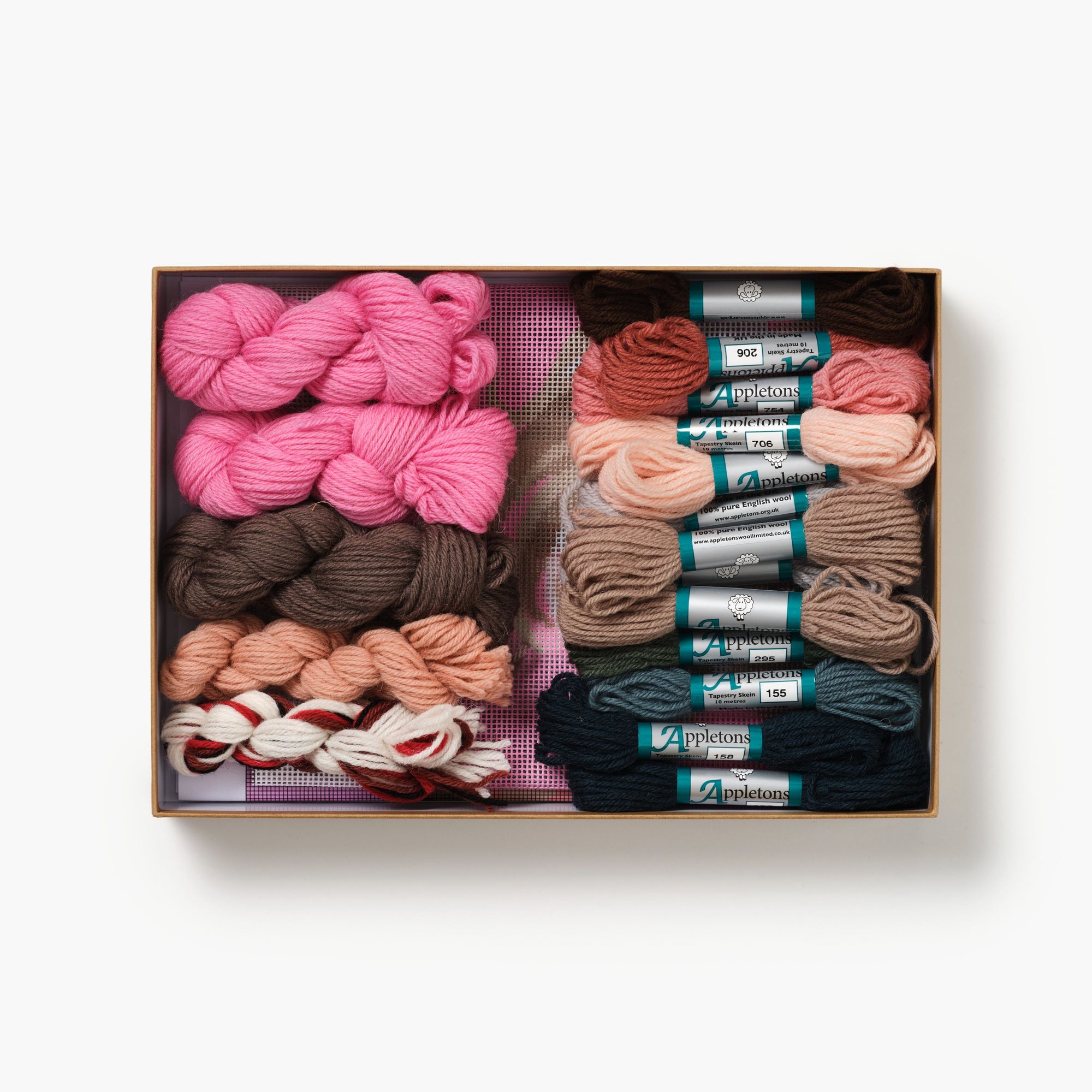 Yarn and embroidery floss set in a box on a white background